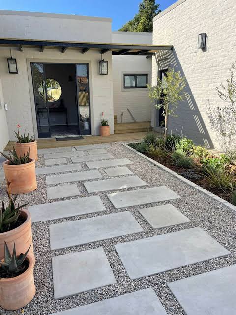 Large concrete slabs set in gravel forming a garden walkway